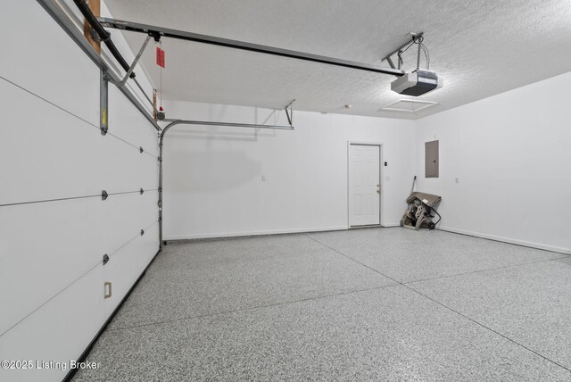 garage with baseboards, a garage door opener, and electric panel