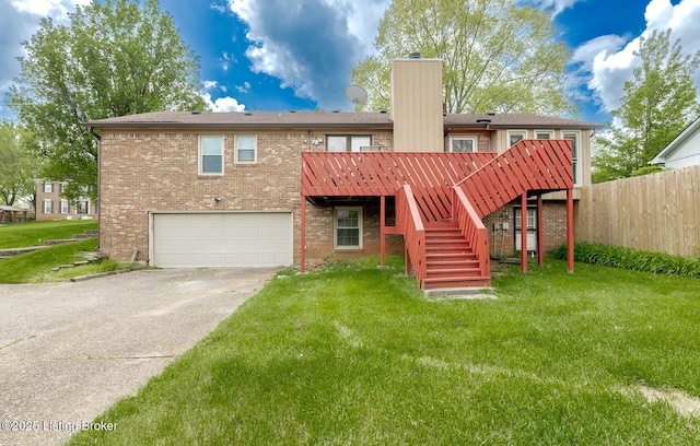 back of property featuring a chimney, a yard, fence, concrete driveway, and stairs