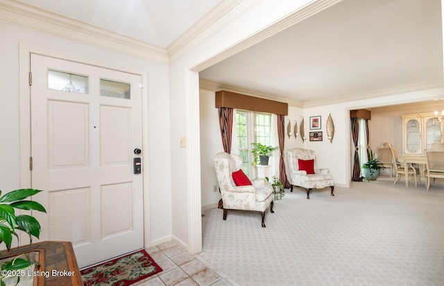 foyer with baseboards, ornamental molding, and light colored carpet