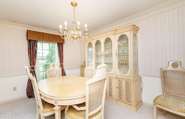 dining area featuring an inviting chandelier, baseboards, crown molding, and light colored carpet