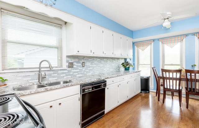 kitchen with decorative backsplash, dishwasher, a sink, white cabinets, and electric stove