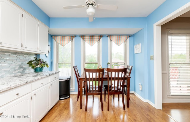 dining room with ceiling fan, plenty of natural light, and light wood-style flooring