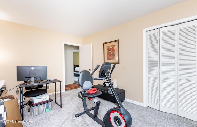 exercise room featuring carpet floors and baseboards