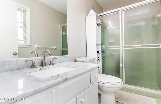 bathroom featuring vanity, tile patterned floors, toilet, and a shower stall