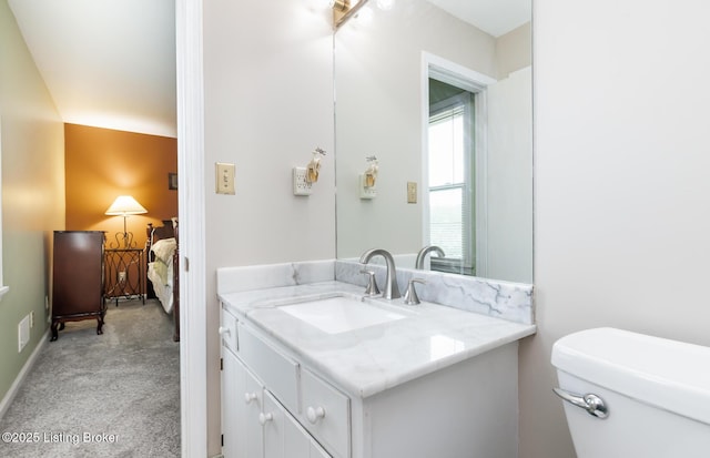 half bath featuring vanity and toilet