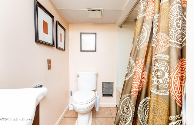 bathroom with baseboards, tile patterned flooring, toilet, and curtained shower