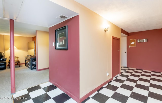 hallway featuring tile patterned floors and visible vents