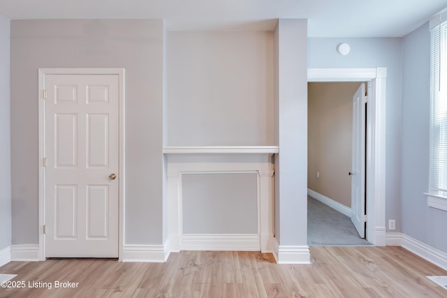 interior space with baseboards and wood finished floors