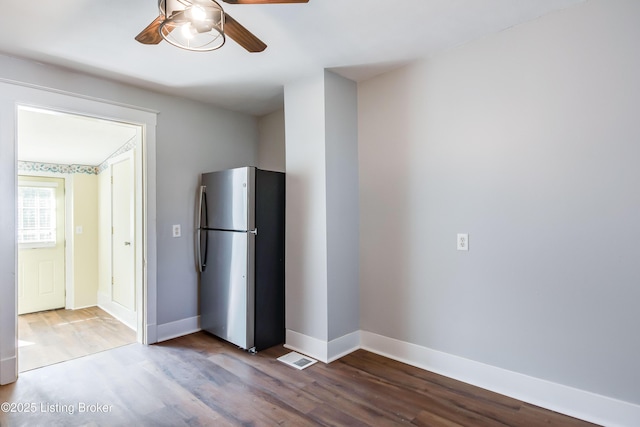 kitchen with baseboards, freestanding refrigerator, a ceiling fan, and wood finished floors