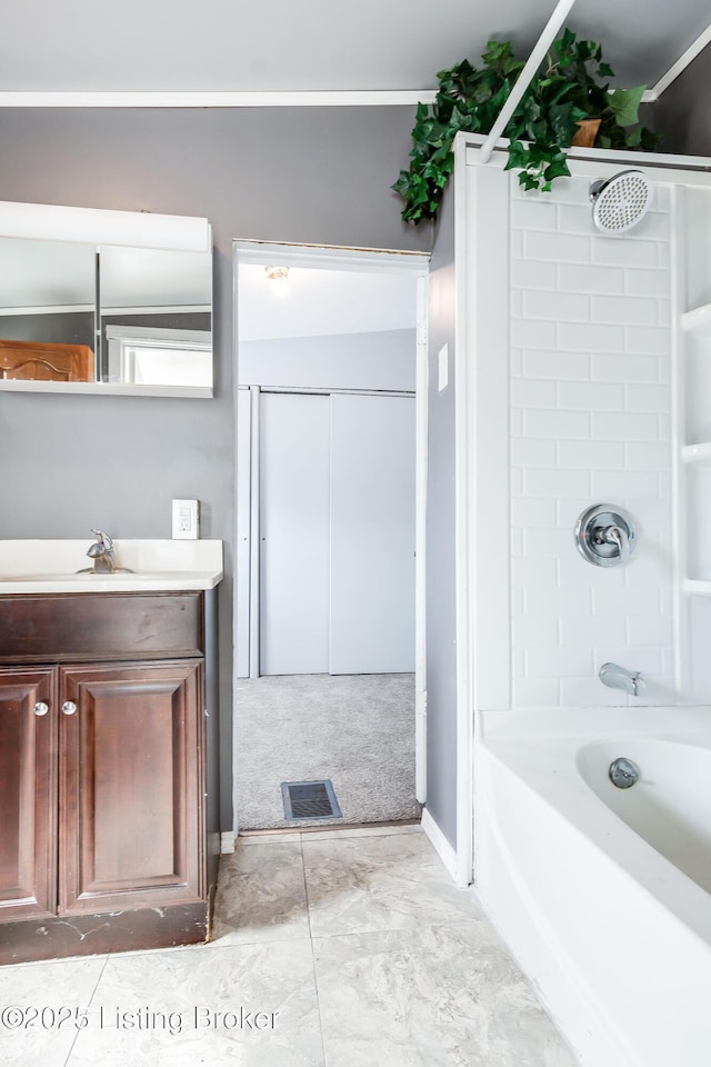 bathroom with bathing tub / shower combination, vanity, and visible vents