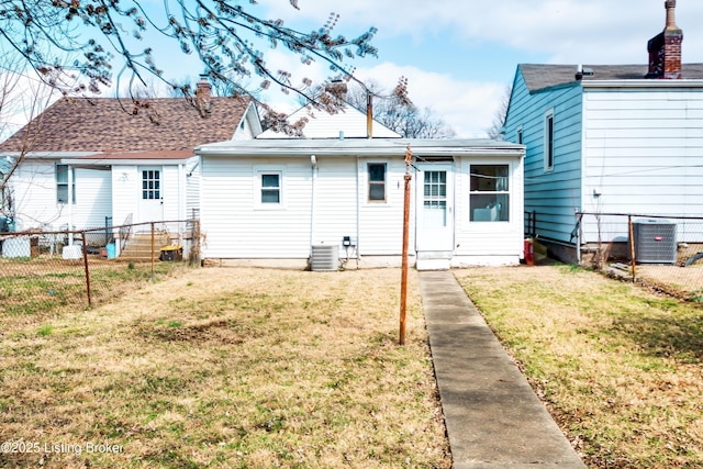 rear view of property with fence, a yard, a chimney, and cooling unit
