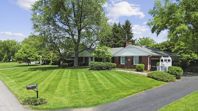 2224 Wynnewood Cir, Louisville, KY 40222 - view of front of home with a front yard, brick siding, and a chimney
