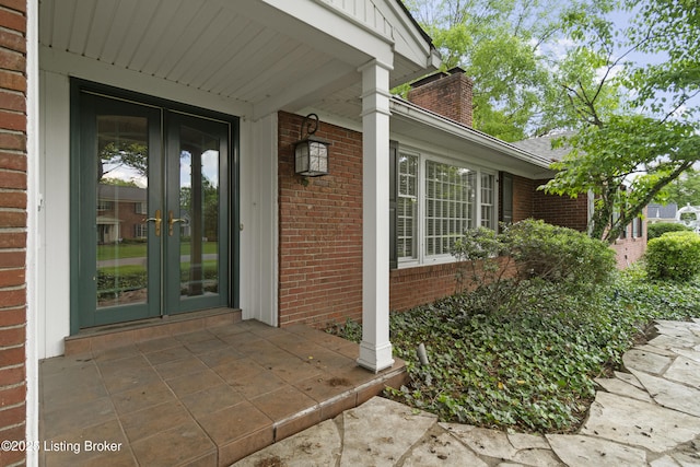 2224 Wynnewood Cir, Louisville, KY 40222 - property entrance featuring french doors, brick siding, and a chimney