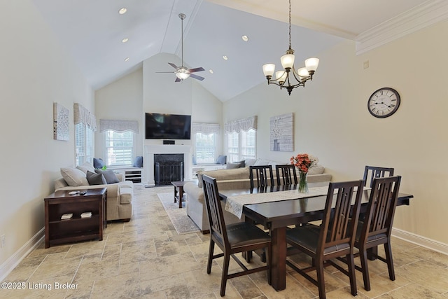 dining area with stone tile flooring, a fireplace, baseboards, high vaulted ceiling, and ceiling fan with notable chandelier
