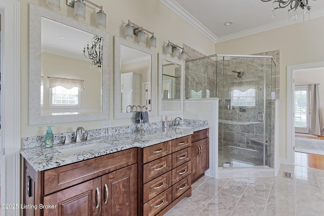 bathroom featuring a sink, ornamental molding, a shower stall, and marble finish floor