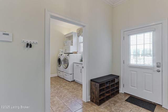 doorway with crown molding, baseboards, and independent washer and dryer