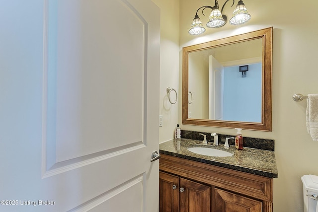 half bathroom with toilet and vanity