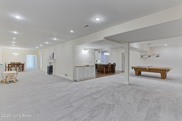 playroom with light colored carpet, bar, and baseboards
