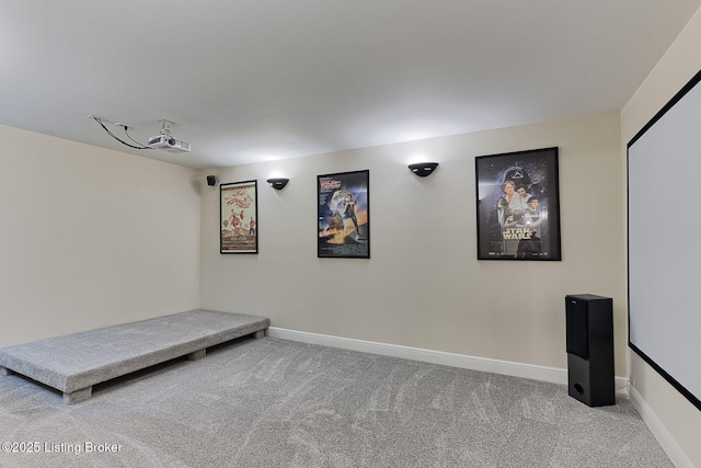 carpeted cinema room with baseboards