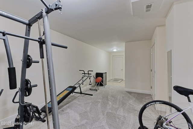 exercise room with visible vents, carpet flooring, and baseboards
