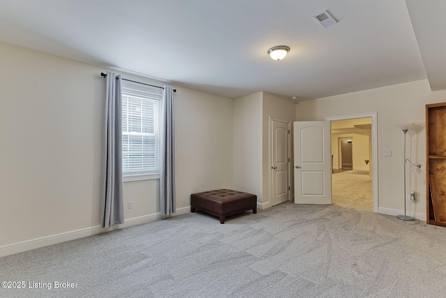 unfurnished bedroom with carpet floors, baseboards, and visible vents