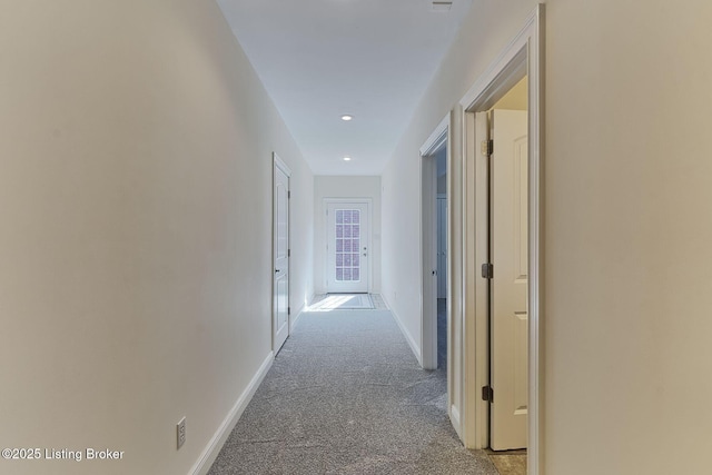 hall featuring baseboards, recessed lighting, and carpet