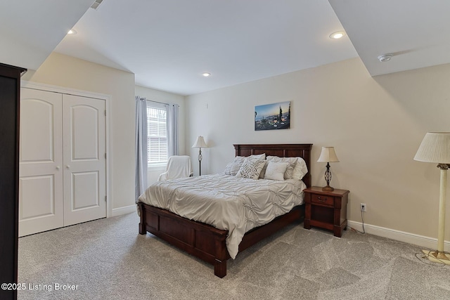 bedroom featuring baseboards, a closet, recessed lighting, and light colored carpet