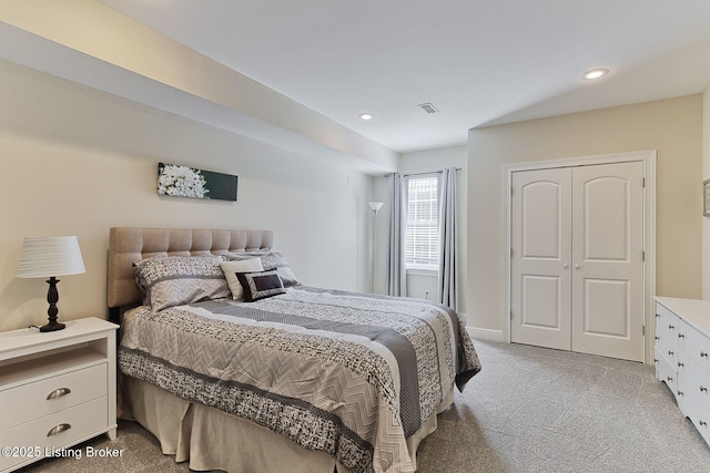 bedroom with light colored carpet, recessed lighting, visible vents, and a closet