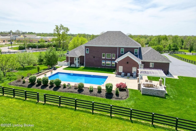view of pool featuring fence private yard, a patio, a fenced in pool, a yard, and a pergola