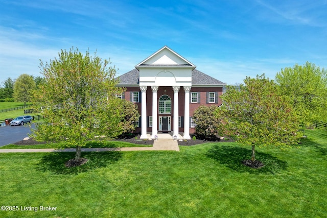 greek revival house featuring roof with shingles and a front lawn