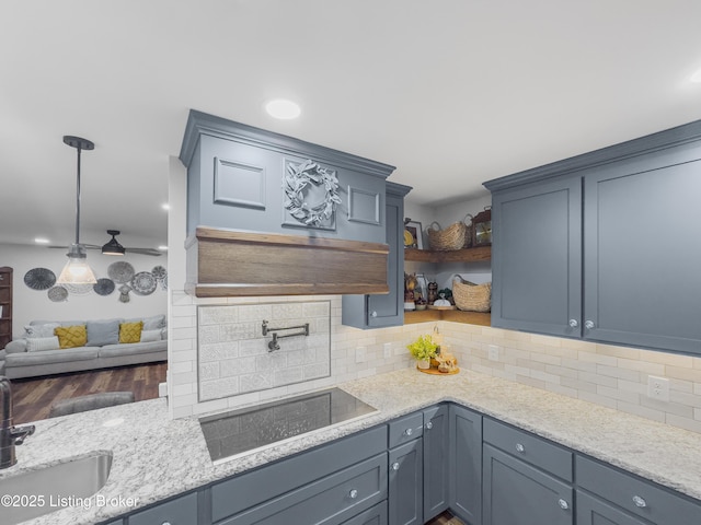 kitchen featuring decorative backsplash, light stone countertops, black electric stovetop, and open shelves