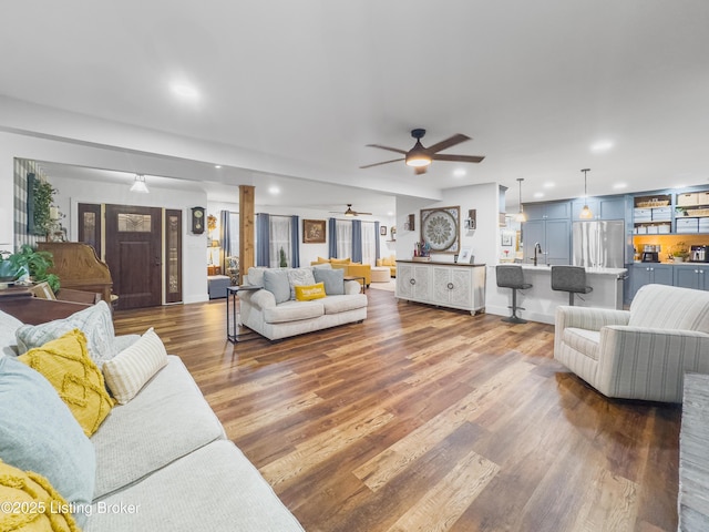 living room featuring a ceiling fan, recessed lighting, and dark wood-style floors