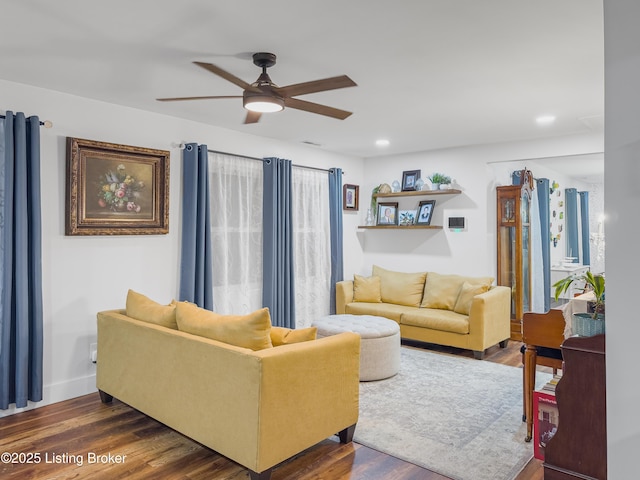 living area with a ceiling fan, recessed lighting, and dark wood-type flooring
