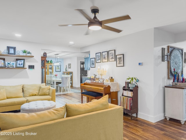 living room with baseboards, ceiling fan, recessed lighting, and wood finished floors