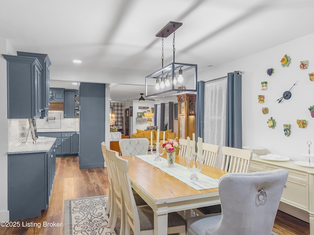 dining room featuring a ceiling fan and dark wood-type flooring