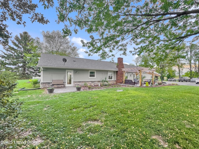rear view of property featuring a chimney, a lawn, a patio area, a pergola, and stone siding