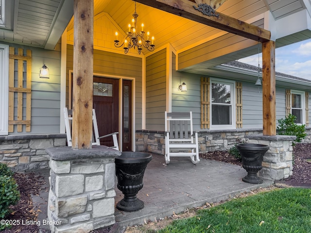 doorway to property featuring covered porch and stone siding