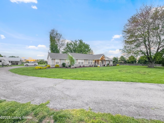 ranch-style home with fence and a front yard