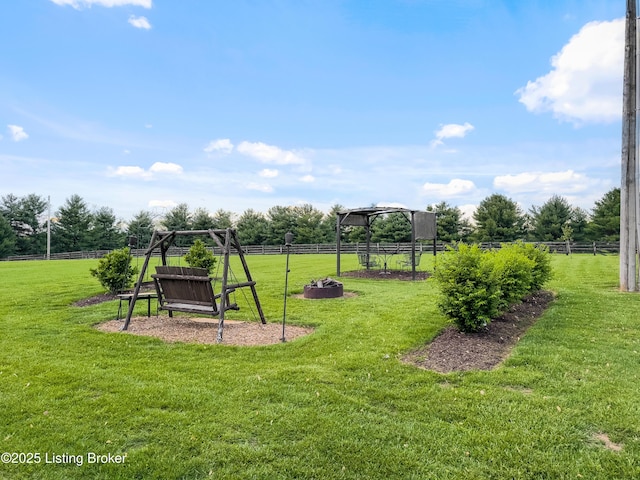 view of playground featuring a yard and fence