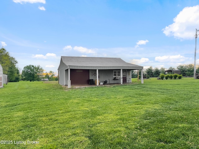 rear view of property featuring a yard