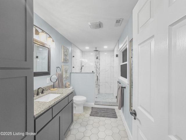bathroom featuring tile patterned flooring, a stall shower, toilet, and vanity