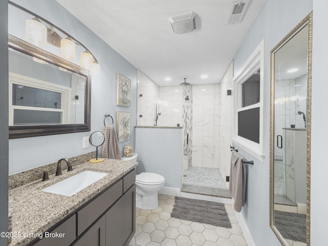 full bathroom featuring visible vents, tile patterned flooring, a stall shower, vanity, and toilet
