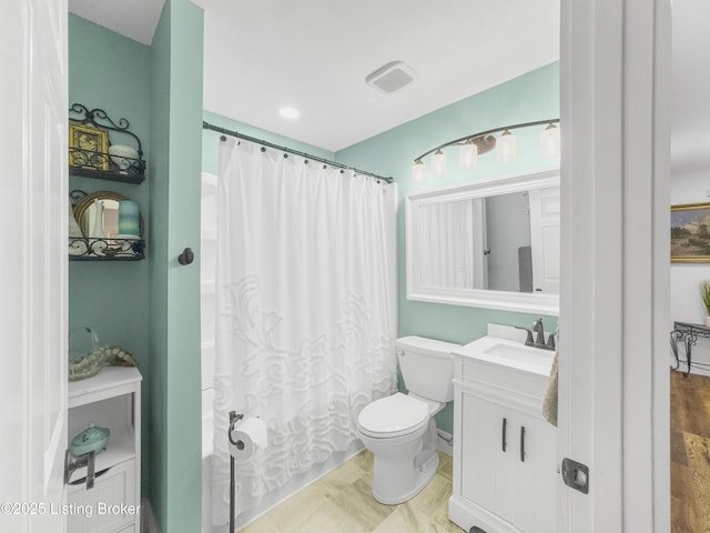 bathroom featuring toilet and vanity
