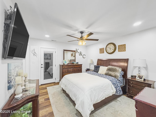 bedroom featuring ceiling fan, recessed lighting, wood finished floors, and access to exterior