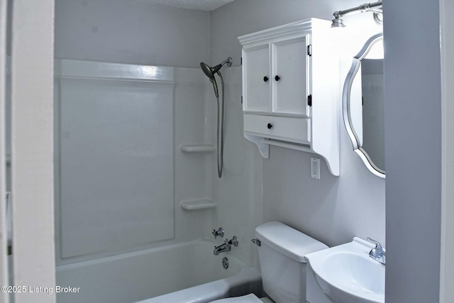 bathroom featuring shower / bath combination, a sink, and toilet