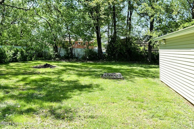 view of yard featuring a fire pit and fence