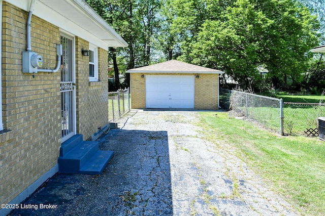 exterior space with an outbuilding, a garage, fence, aphalt driveway, and entry steps
