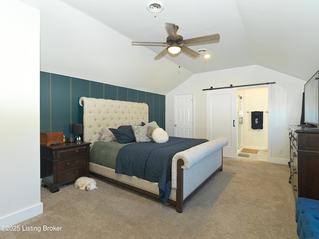 carpeted bedroom featuring baseboards, ensuite bathroom, a barn door, and lofted ceiling