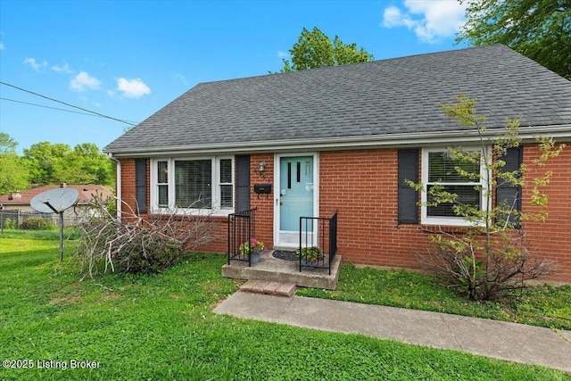 bungalow-style home featuring brick siding, a front lawn, roof with shingles, and fence
