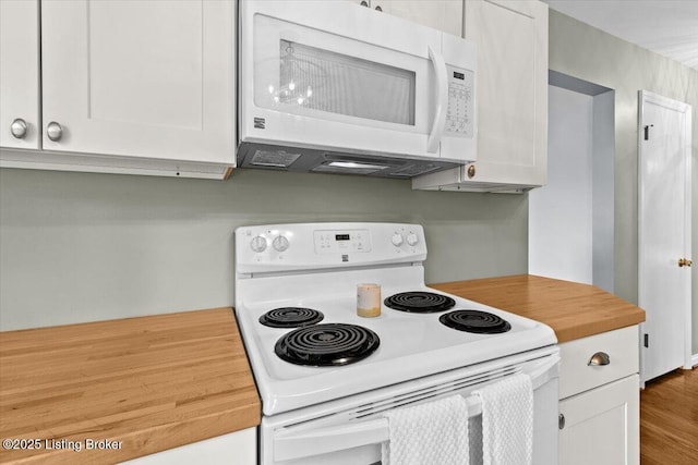 kitchen featuring white cabinets, wooden counters, white appliances, and wood finished floors